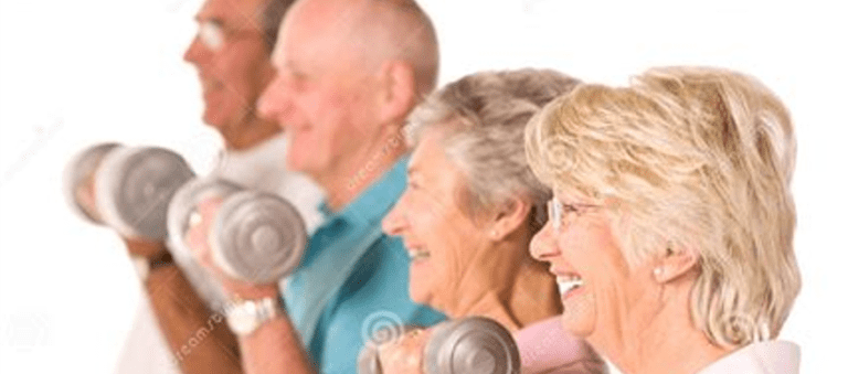 A group of people holding up dumbbells in a gym.